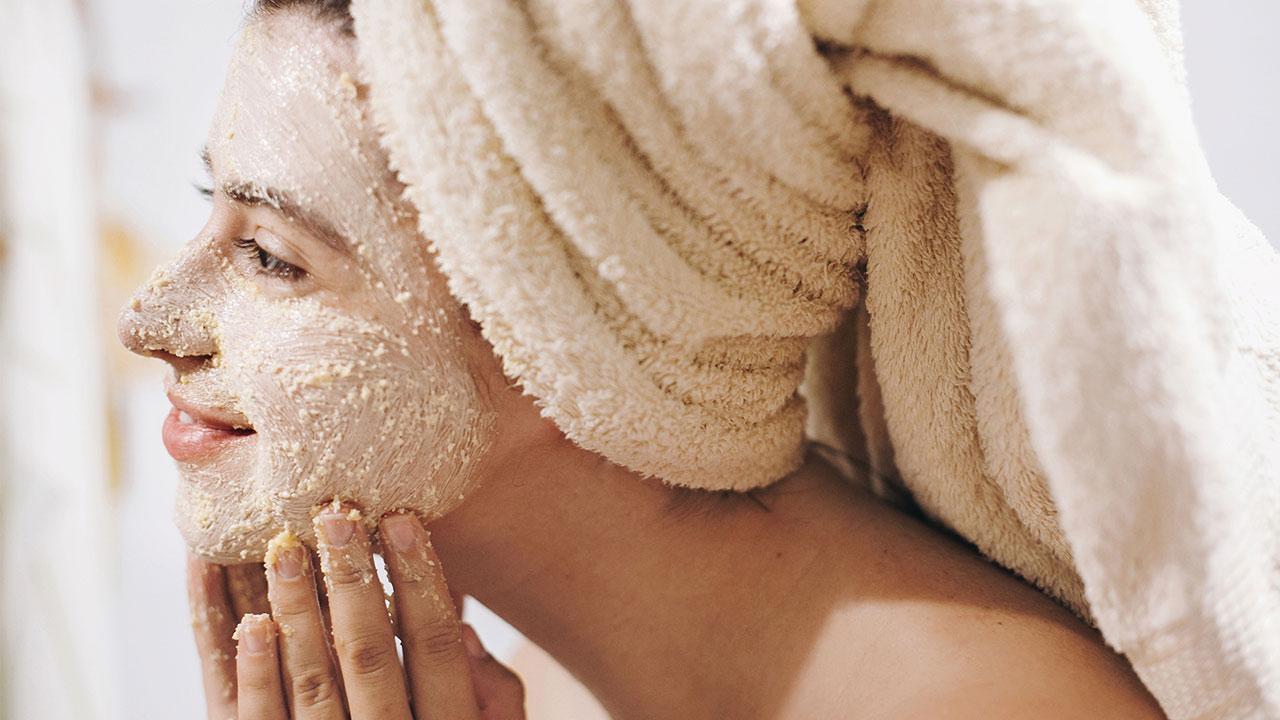 DIY peeling - woman applies a face peeling