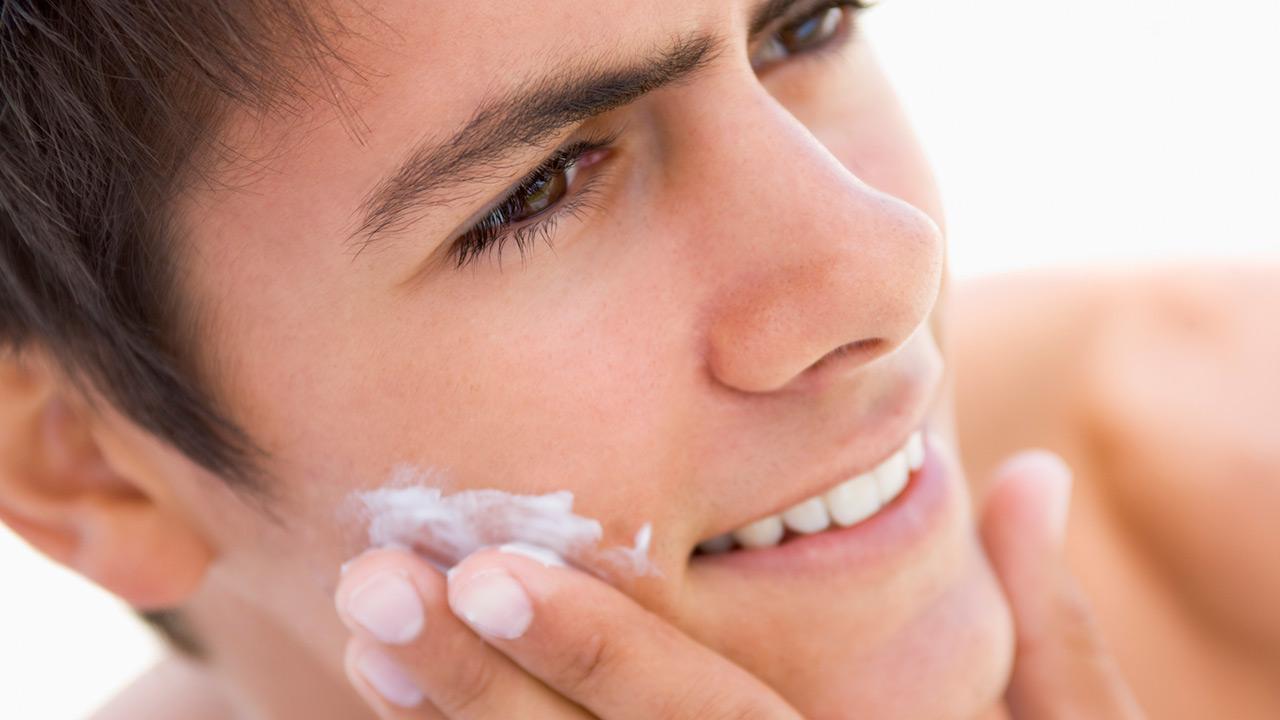 Which care cream does the modern man need - young man creams his face