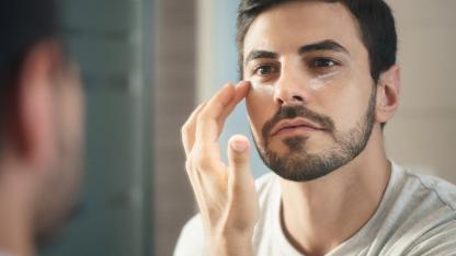 Which care cream does the modern man need - man applies eye cream